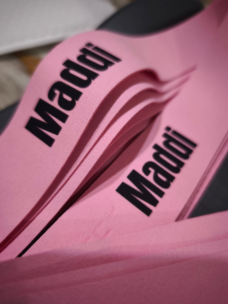 A name printed in black on pink custom Griptonyte grips